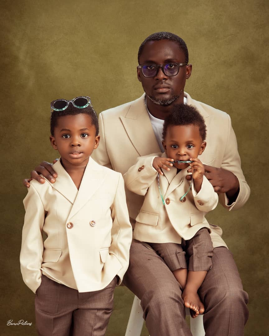 Father & sons in coordinated cream tailoring.