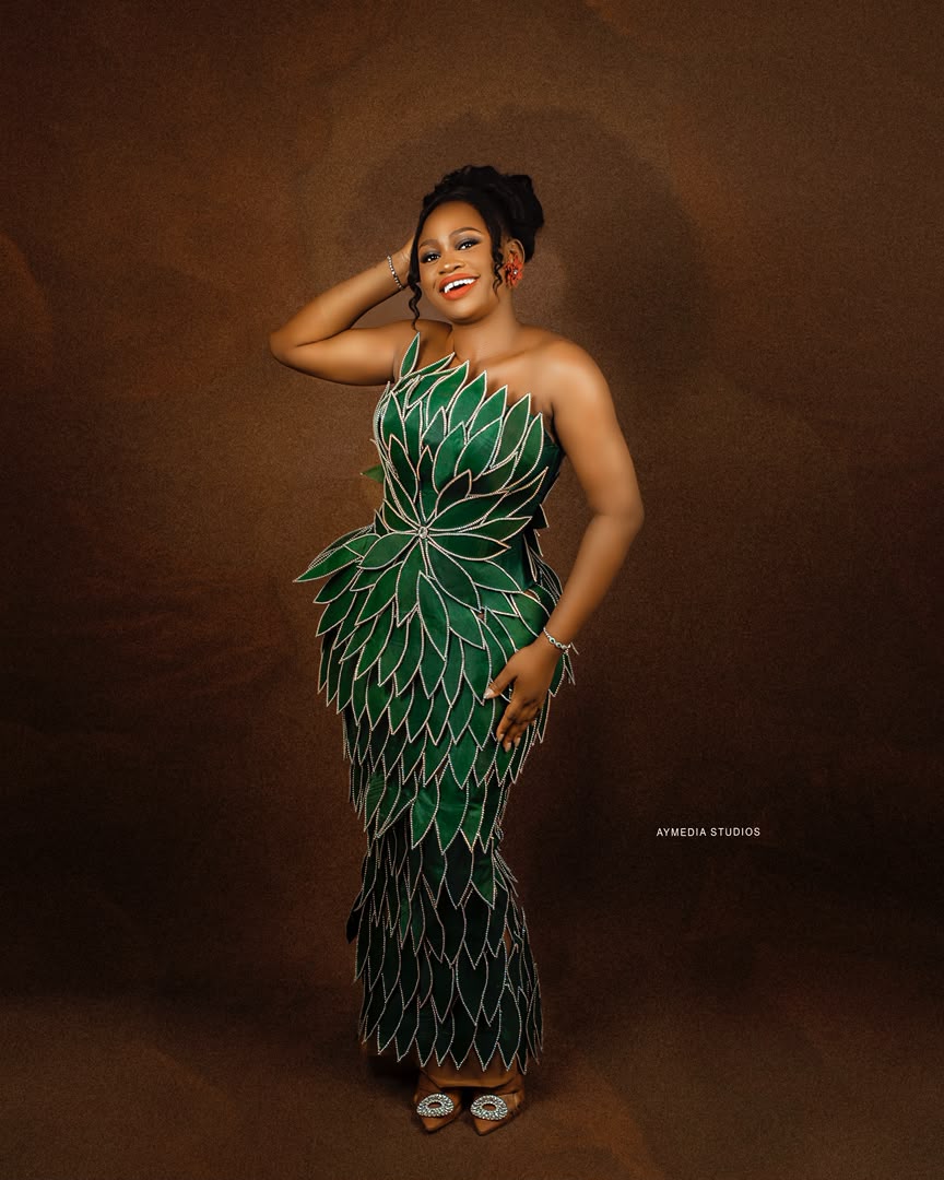 The founder in a signature green leaf-patterned bespoke gown